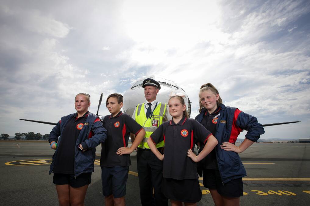 READY FOR TAKE OFF: Captain Ben Jones with Springdale Heights Public School students Addyson Elkner, 11, Talyn Crupi, 11, Ziggy Holding, 10, and Tiana Harmer, 11. Picture: JAMES WILTSHIRE