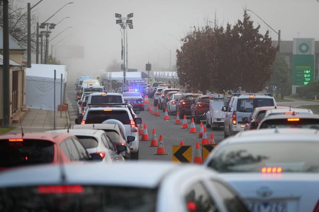 BORDER CROSSING: Cars line up at the Wodonga Place, Albury, checkpoint on Wednesday. Picture: JAMES WILTSHIRE