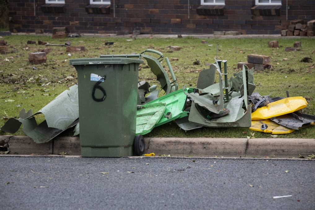 CRUMPLED: These household wheelie bins came off second best in the collision. Picture: ASH SMITH