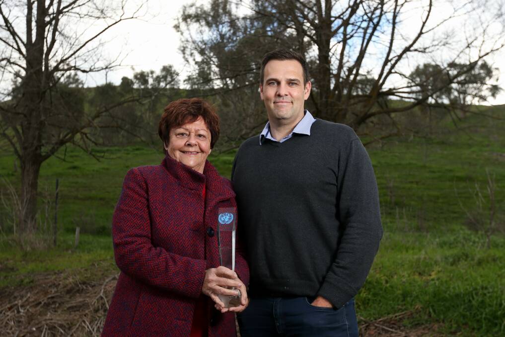 SUCCESS: Victorian Rabbit Action Network's Lyn Coulston and Agriculture Victoria program manager Michael Reid with the United Nations award. Picture: TARA TREWHELLA