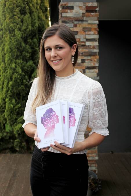 LATEST VENTURE: Film maker and writer Grace Griffith with copies of But You Look Okay, which is now available. Proceeds will go towards inflammatory bowel disease research and support.
