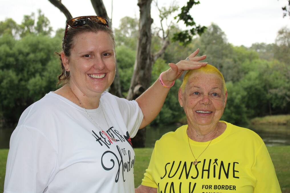 SHARED CAUSE: Hearts of Howlong team captain Regan Lions and fellow team member Marie Orr after the latter's fundraising head shave at Noreuil Park. Picture: SUPPLIED