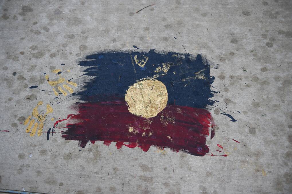 RETAINED: Other graffiti was removed, but not this Aboriginal flag on the footpath. Picture: MARK JESSER