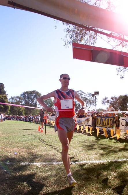 UNBEATEN RUN: Marathon man Steve Moneghetti crosses the finishing line at Noreuil Park in the 2003 Nail Can Hill Run, breaking the previous record by about two minutes.