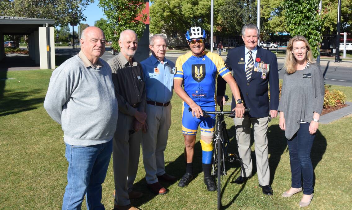 WELCOMING PARTY: The rider is greeted by Wodonga and Albury veterans and council representatives Rob Patterson, David Thurley, Gary Treeve, Graham Docksey and Kim Strang.