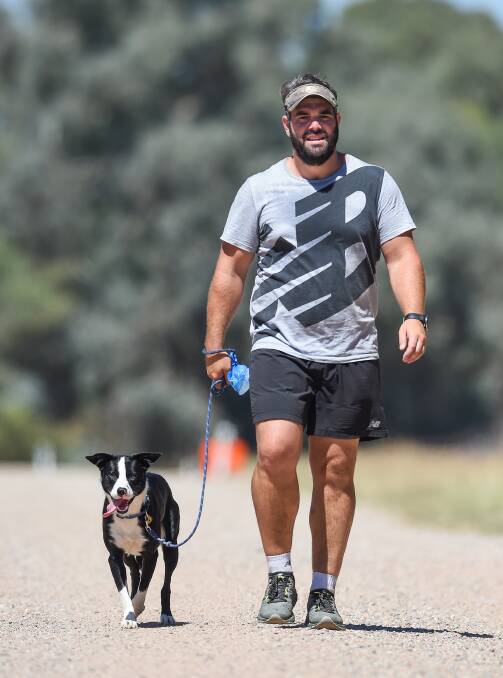 SMALL STEPS: Joey Rush and his dog Jonty walk near Table Top on Sunday during his trek from Melbourne to Canberra to support the work of Beyond Blue. Picture: MARK JESSER