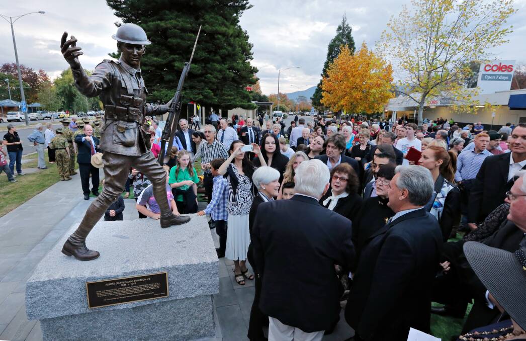 WAR HERO REMEMBERED: Crowds mill around in front of the bronze statue of Myrtleford's Alby Lowerson after its official unveiling on April 23, 2015.