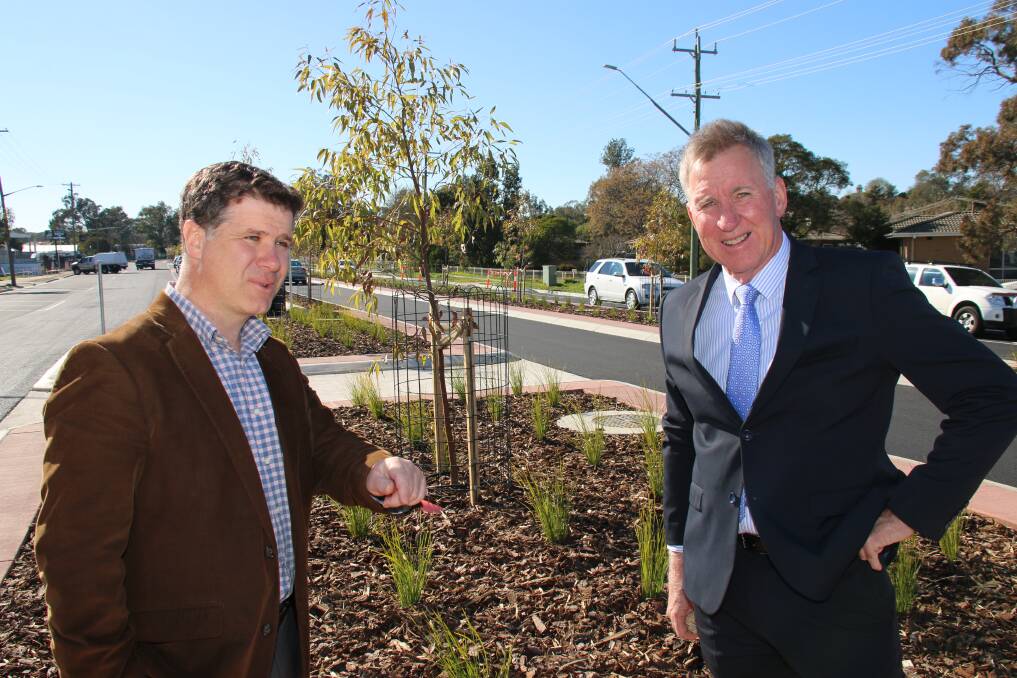 STREET TRANSFORMED: Member for Albury Justin Clancy and Albury mayor Kevin Mack look over stage two of the Wagga Road, Lavington, redevelopment between Kaylock Road and Barlow Street. Stage one from Urana Road to Kaylock Road was completed in 2016.
