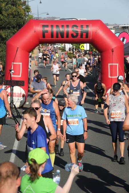 TIME TO RELAX: It's mission accomplished as runners cross the finish line at Junction Place. Picture: KYLIE ESLER