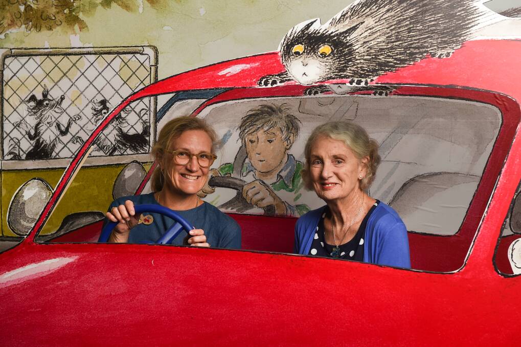 FORGING AHEAD: Curator of The Lynley Dodd Story Penelope Jackson and Dame Lynley Dodd sample one of the exhibits at Albury Library Museum. "It's always strange for me because I never have seen large chunks of my work at the same time, normally it's one book at a time," Dame Lynley says. Picture: MARK JESSER