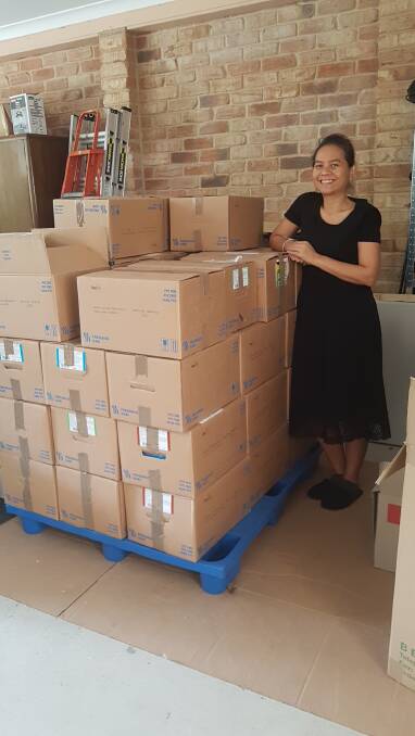 READY FOR SHIPPING: Suthatta Kanprom stands with Books For Kids Global's third collection of books donated by the public.