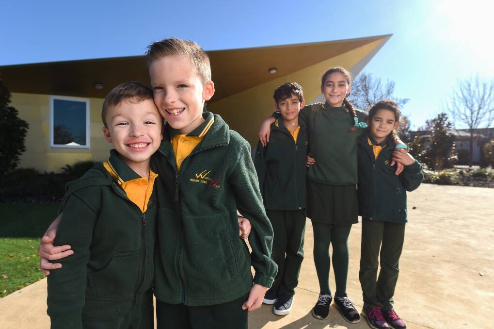 REUNITED: Brothers Caeleb and Keiran Guthridge and siblings Kaegan, Sharnaea and Lanicah Hall-Bidois enjoy all being back at Wodonga West Primary School once more. Picture: MARK JESSER