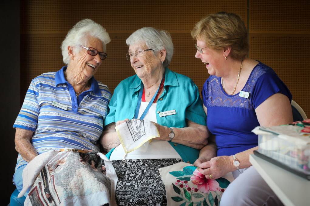 SHARING TALENTS: Albury-Wodonga branch members Joan Whitsed, Magg Stuchbery and Sue Hitchins talk together at Tuesday's stitching day. Picture: KYLIE ESLER