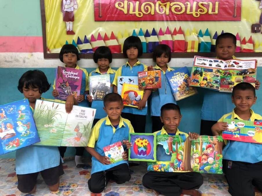 GIFT GIVING: School students in Surin display the colourful book collection sent from Albury-Wodonga.