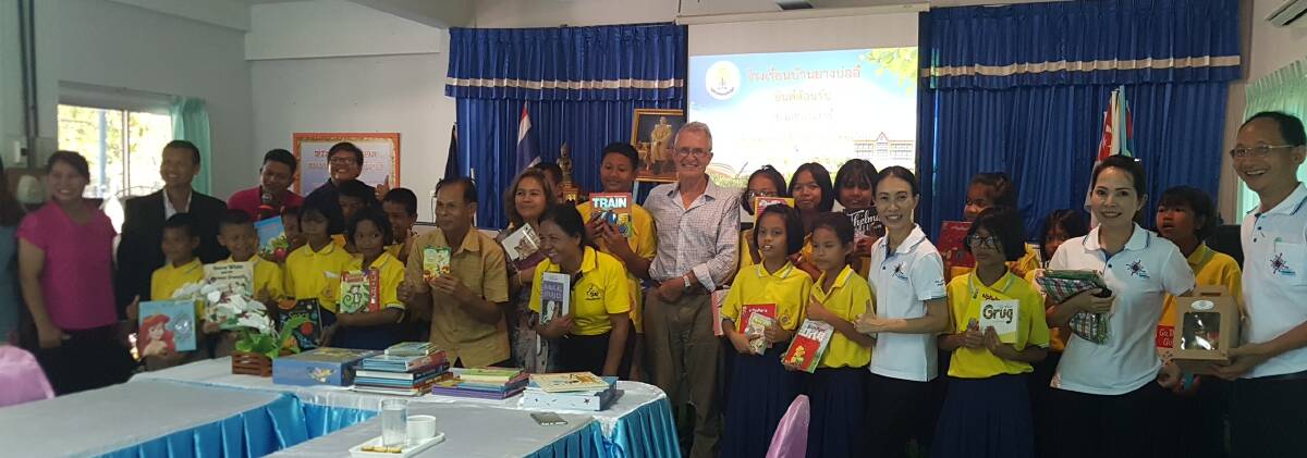 DISTRIBUTION: Rotary Club of Wodonga West president Jos Weemaes helps present donated books to primary schools in Thailand through an Albury-Wodonga appeal that supports the children's English language development.