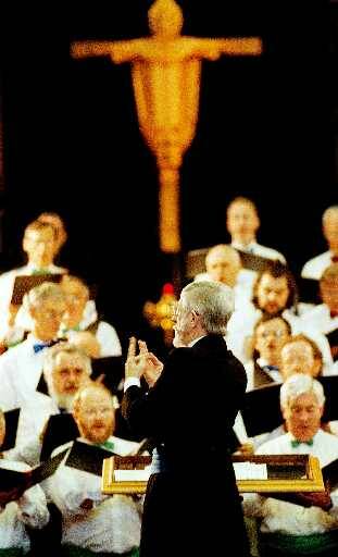 CONDUCTOR AT WORK: David Carolane leads the singers at the Three Choirs Festival in Wangaratta in September 1998.