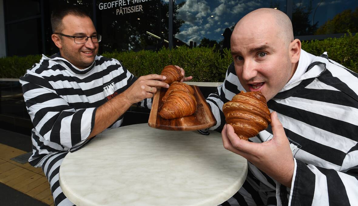 HANDS OFF: PCYC prisoner Rad Sredojevic, of Pixel Accountants, tries to nab a croissant from fellow inmate and patissier Geoffrey Michael as both business owners prepare to be incarcerated in Time 4 Kids. Picture: MARK JESSER