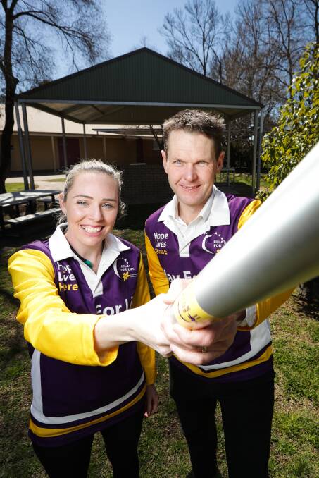INNOVATION: Border Relay For Life committee members Carl Friedlieb and Cristy Jacka thank Signarama Albury-Wodonga and JC Butko Engineering for their generous support of the new Border Baton. Picture: JAMES WILTSHIRE