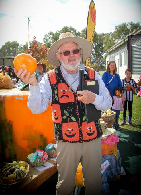 EMBRACING THE THEME: Royce Sample, along with Chris Griffith, weighed and judged the pumpkin competition at Murmungee's annual harvest festival on Saturday. Picture: KERRI-ANNE SERONG