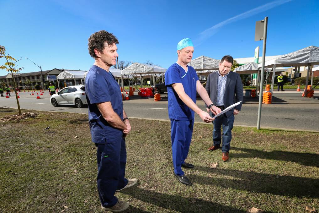 OPEN LETTER: Albury-Wodonga doctors Mark Norden, Jonathan Lewin and Craig Underhill outline their concerns near the border checkpoint in Albury on Friday. Picture: JAMES WILTSHIRE