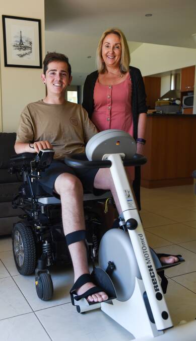 REGULAR THERAPY: Nick Dempsey uses a motorised exercise bike watched by his mother Trudy during a physiotherapy session yesterday. Picture: MARK JESSER