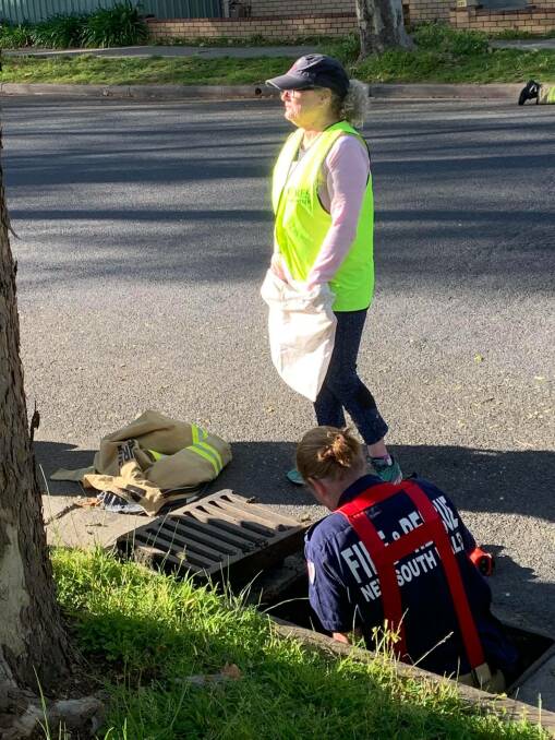 ROADSIDE RESCUE: Senior firefighter Bridget McCloskey, of Albury Central, prepares to enter the drain in search of ducklings. Picture: FIRE AND RESCUE NSW ALBURY CENTRAL
