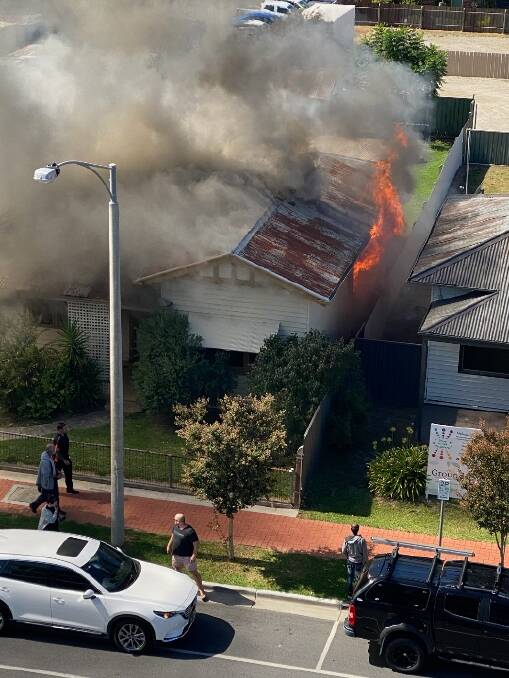 HOUSE FIRE: Flames can be seen in the roof of the Hume Street property.