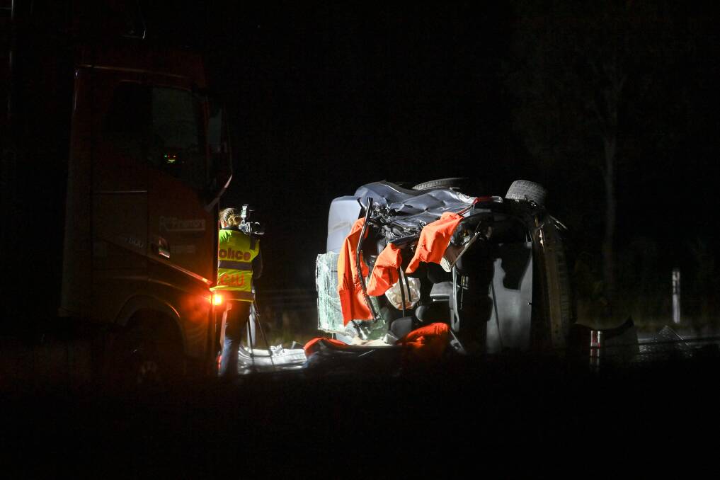 Investigation officers work into the night at the scene of a fatal Hume Freeway crash near Chiltern in August that claimed four lives. Picture by Mark Jesser