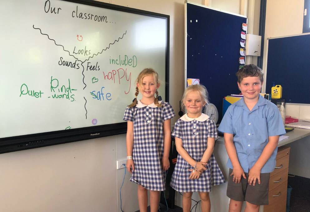 LEARNING RESOURCE: St Joseph's School Lockhart students Isla Trevaskis, Scarlett Pearse and Dougal Gleeson try out the new interactive display in their classroom.