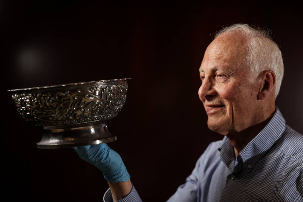 SIGNIFICANT STORY: Uiver historian Noel Jackling admires the silver bowl given to Albury's Beatrice Peacock in 1934. Picture: JAMES WILTSHIRE