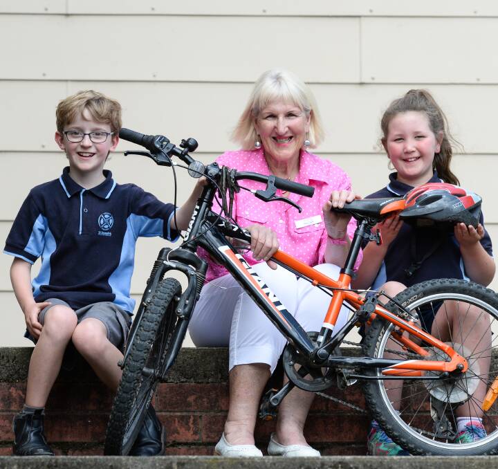 RIDING RULES: St Joseph's Beechworth students Oscar Brundell and Ruby Allison, both 10 and in grade 4, talk with safety advocate Mary Safe while Amy's Share The Road Tour visited their school on Monday. Pictures: MARK JESSER