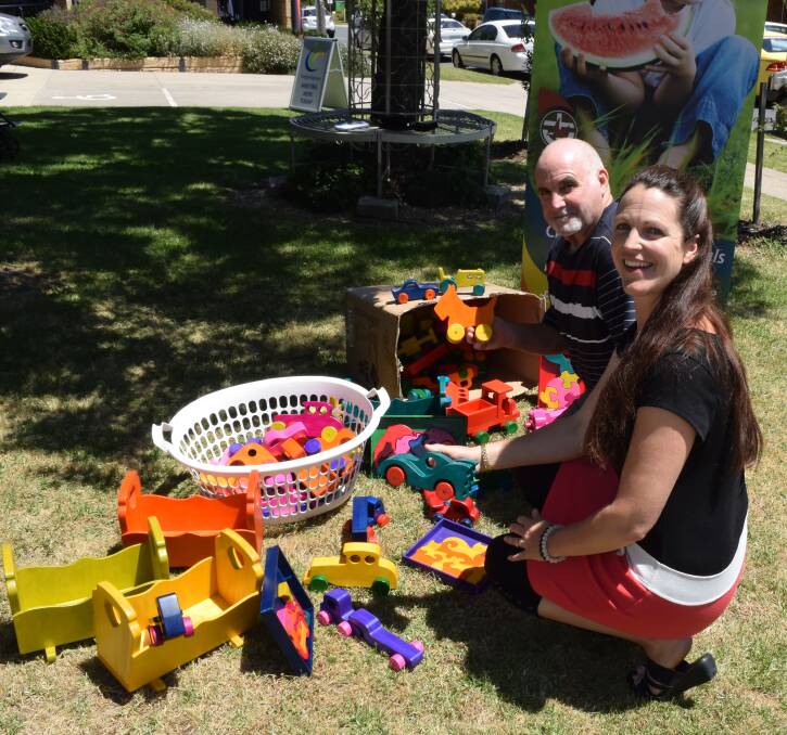 COLOURFUL COLLECTION: Laurie Smith, of Lavington, looks over his wooden toy donations with Uniting Care Wodonga manager Naomi Jansen.