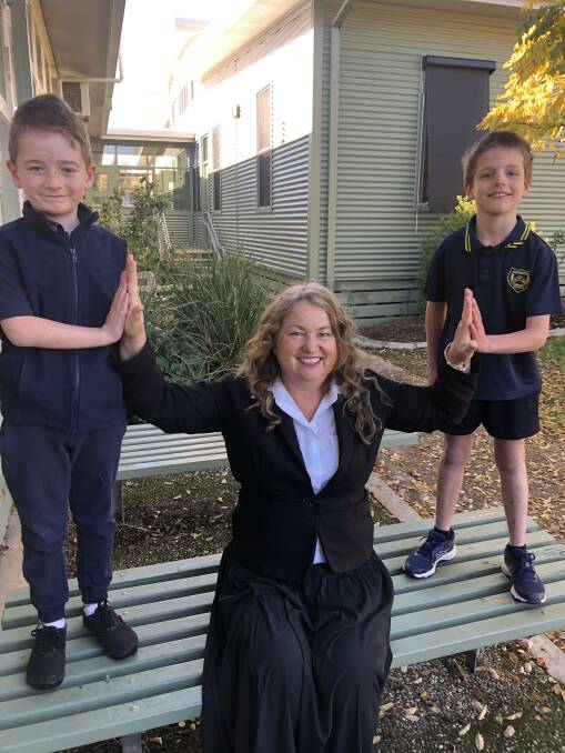 WAY TO GO: Bandiana Primary School students Seth Deslandes and Spencer Maling congratulate their principal Donna Wright, who is in the running for an Australian Education Award.