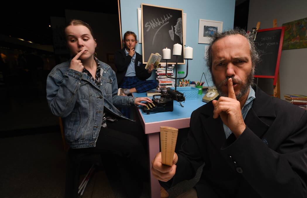 SCHOOL SCENE: Hidden Cinema performers Micaela Schmidt, Maddie McTernan, 9, and Chris Amor aren't telling, but may be giving away a few hints. Picture: MARK JESSER