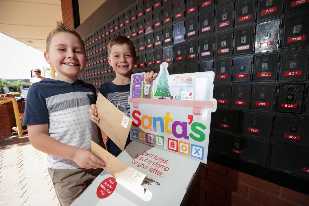 DEAR SANTA: Darcy Harvey and Ethan Montoneri, both 7, mail their Christmas letters at Wodonga Post Office, two of more than 150,000 nationwide. Picture: JAMES WILTSHIRE