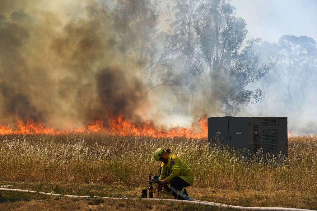 EMERGENCY IN PROGRESS: Grass goes up in flames at Ceres Drive, Thurgoona, on Tuesday. Picture: MARK JESSER
