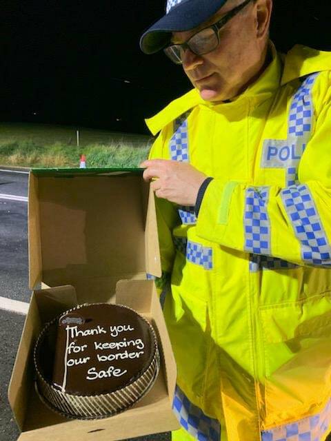SHOW OF APPRECIATION: Officers working at Lake Hume receive a thank-you cake. Picture: NSW POLICE