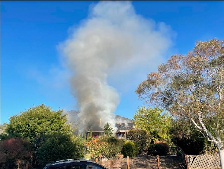 Smoke can be seen coming from the Brewer Drive house in west Wodonga. Picture by Blair Thomson