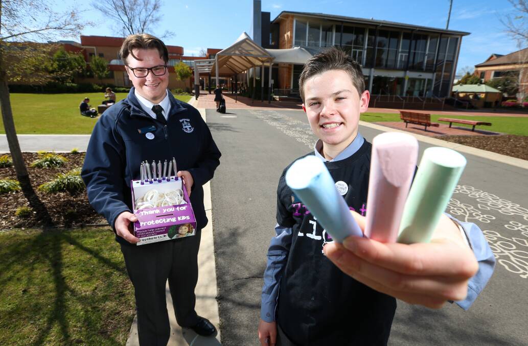 IMPORTANT MESSAGE: Albury youth councillors Eli Davern and Jack Kelso will sell pens, badges and wristbands as part of White Balloon Day. Picture: JAMES WILTSHIRE
