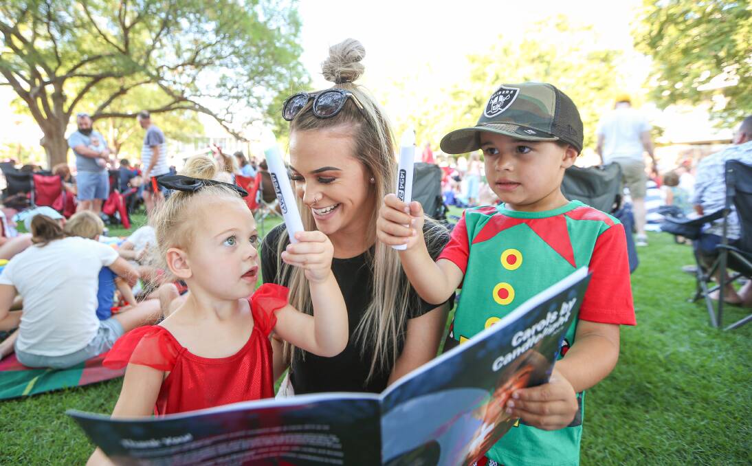 FAMILY OUTING: Thurgoona's Linita Boulton and her children Livvie, 2, and Luka, 4, enjoy singing the Christmas carols together. Picture: JAMES WILTSHIRE