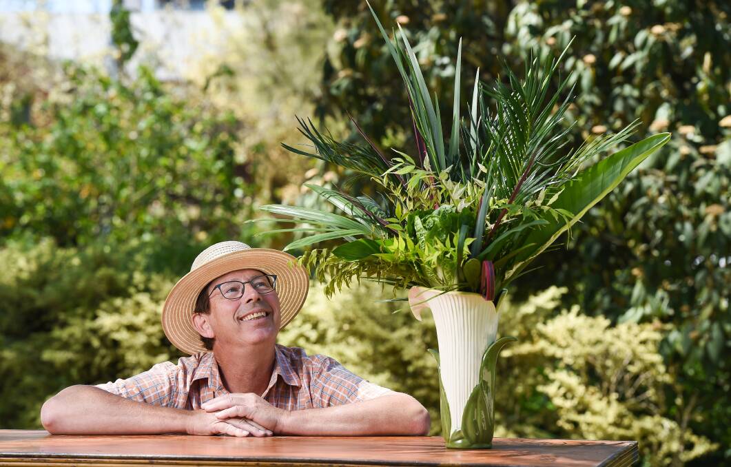FINE STYLE: Gardening Australia's Jerry Coleby-Williams admires a winning floral design display during Gardenesque on Saturday. Picture: MARK JESSER