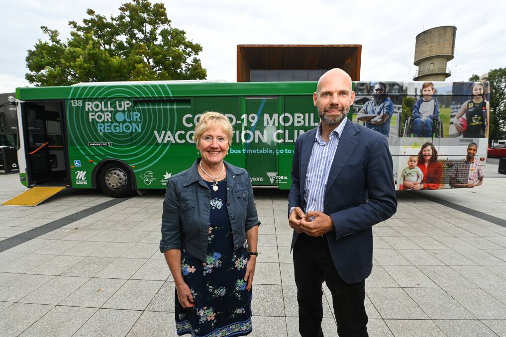 BORDER VISIT: Albury Wodonga Health interim chief executive Janet Chapman and Victorian COVID-19 response commander Jeroen Weimar stand in front of Reggie the mobile vaccination bus during Mr Weimar's trip to Wodonga on Monday. Picture: MARK JESSER
