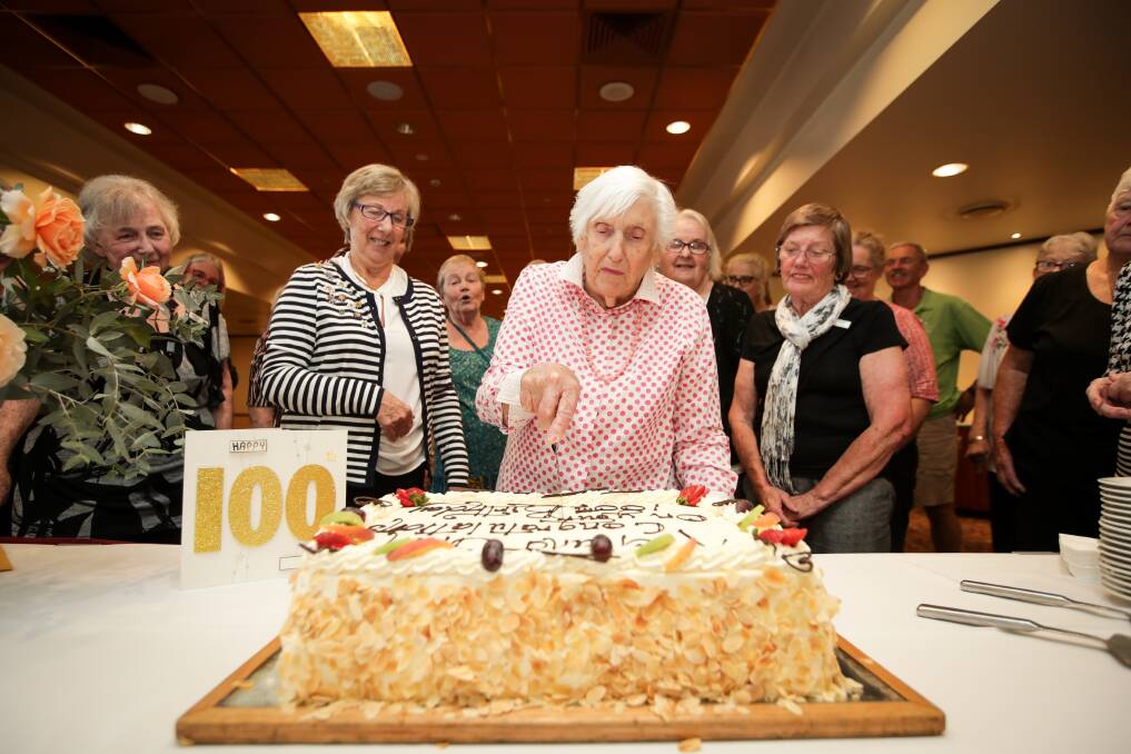 MARKING THE OCCASION: Edna Bramley cuts a birthday cake on Friday watched by fellow Commercial Club Albury Bridge Club members. Picture: JAMES WILTSHIRE