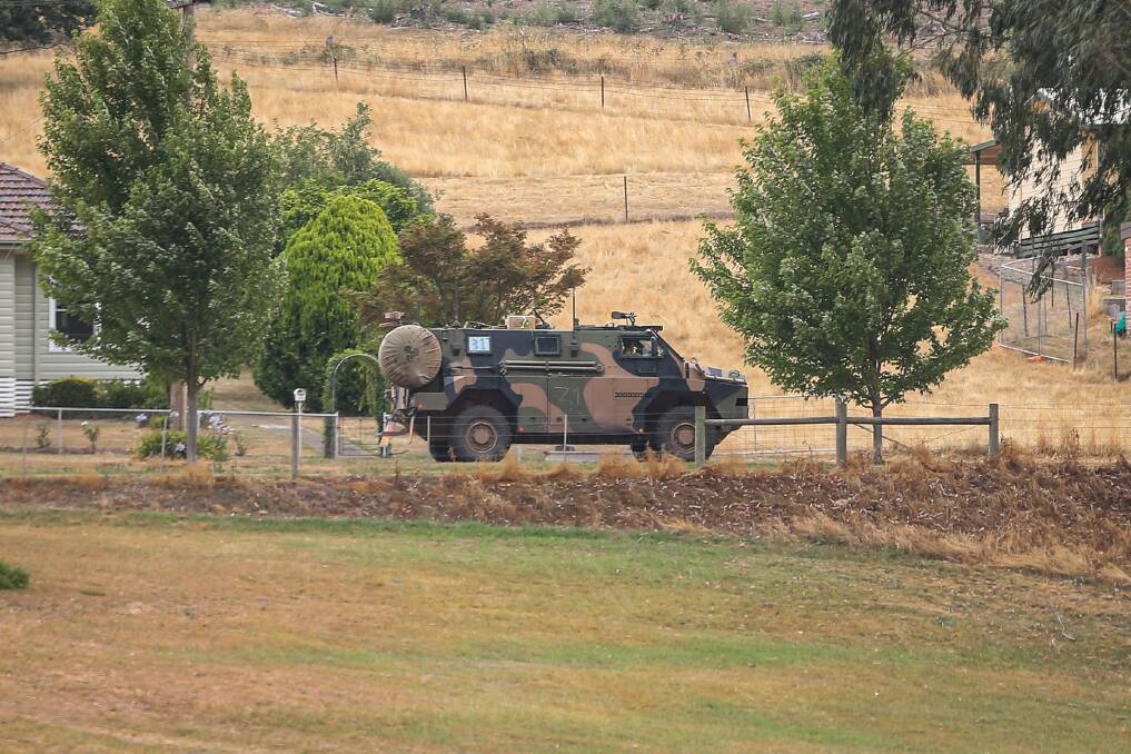 FIRE ASSISTANCE: ADF Bushmasters travel around Bright on Friday afternoon. Picture: JAMES WILTSHIRE