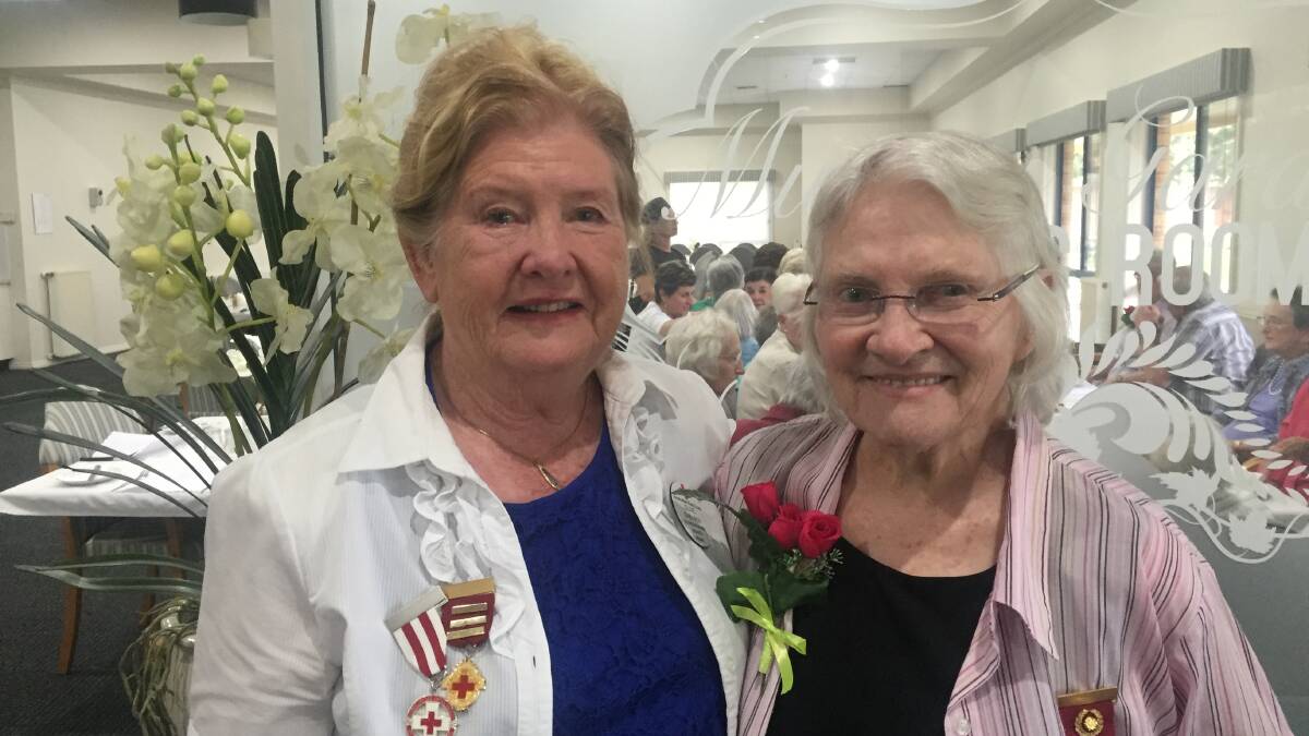 CONGRATULATIONS: Bungowannah Red Cross branch president Olive Shearer and volunteer Eve Ross, 89, celebrate Mrs Ross' 60 years as a Red Cross volunteer.