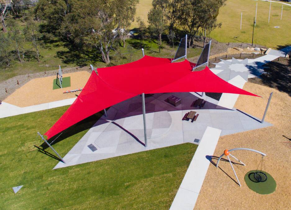 AIR COVER FLYING OVER: The bright red shade sail that brings sun protection to this White Box Rise recreational area just happens to form the shape of a fighter plane.