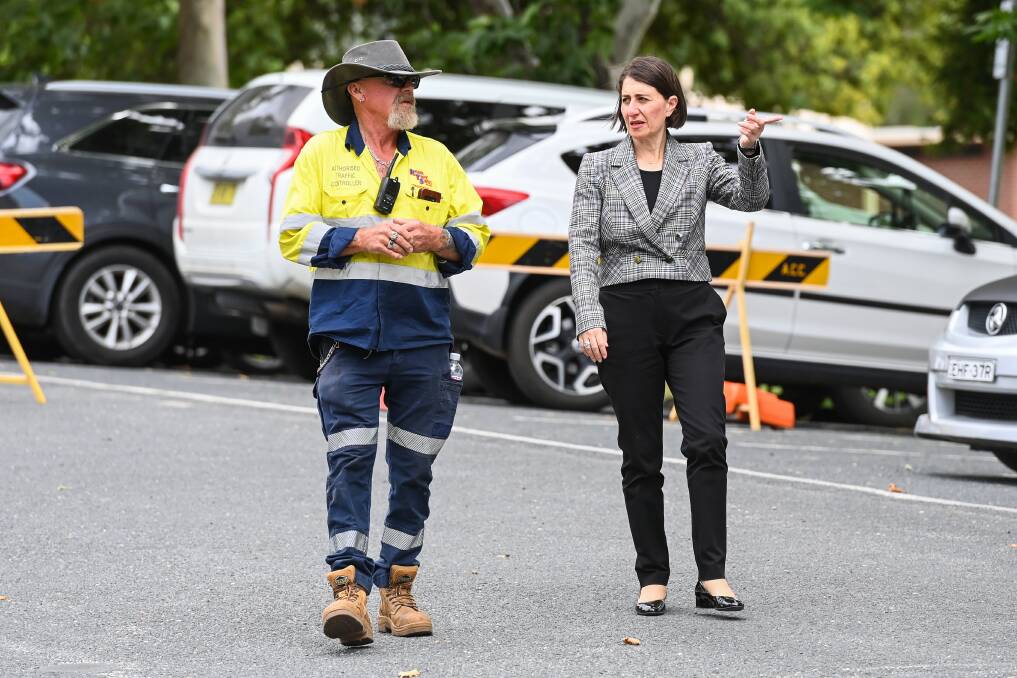 WHAT NOW: NSW Premier Gladys Berejiklian talks to Rod Smith, of Riverina Traffic Services while visiting the Albury checkpoint just before the border reopened last month. The current Northern Beaches COVID-19 cluster is causing concern. Picture: MARK JESSER