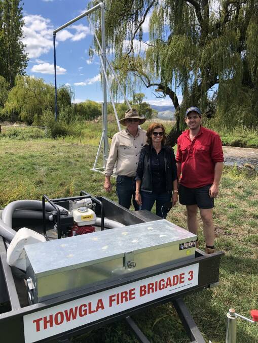 COMMUNITY EFFORT: James Paton with his parents Doug and Jan Paton, of Invarelle in Thowgla Valley. The new portable quick-fill pumps and stand pipes provide an effective way to safely and quickly refill slip-ons, tanks and other fire fighting tanks so that locals can get straight back to fight the fire front. 