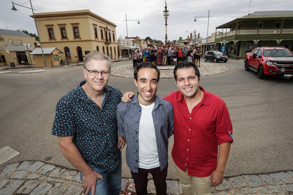 TAKING OVER THE TOWN: Opera in the Alps conductor Guy Noble, tenors Brenton Spiteri and Mark Vincent with the other singers in Beechworth. Picture: JAMES WILTSHIRE