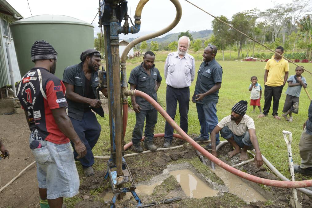 Albury engineer Charles Knight oversees a project in Papua New Guinea to drill a bore hole and install a hand pump to provide a remote school with running water. Pictures: REDR AUSTRALIA/LAURENCE ROE